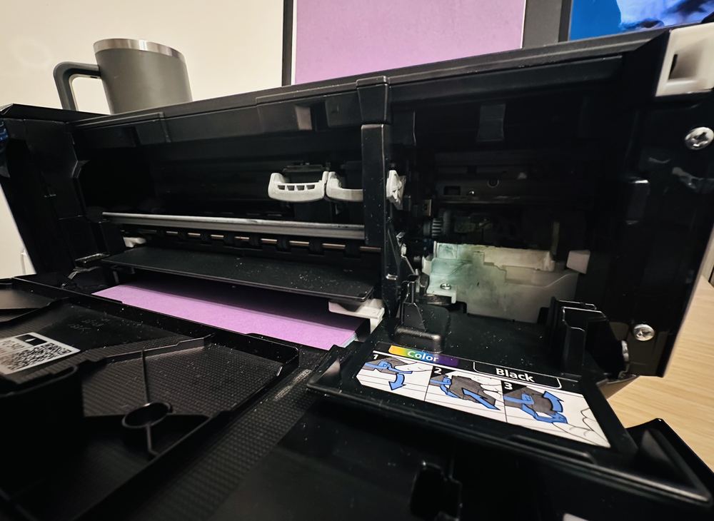 Printer opened up to clear a paper jam